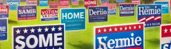 A vibrant scene showcasing high-quality lawn signs for a political campaign, placed in a well-maintained residential neighborhood with green lawns and houses in the background.
